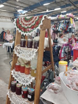 Jelly Gal jams, jellies and pickles on a display rack at a holiday bazaar